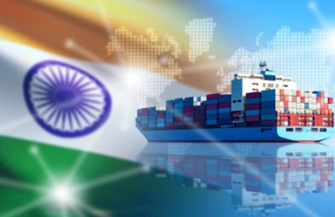 An Indian national flag depicted in front of a cargo ship
